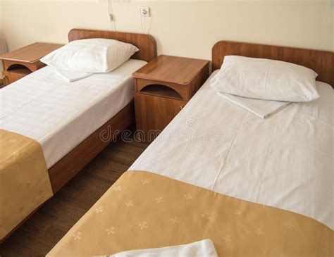 Hotel Room With Two Empty Single Beds And Bedside Tables The Concept