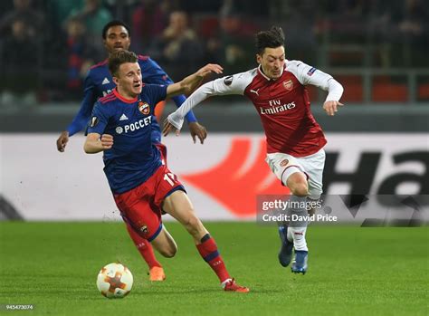 Mesut Ozil Of Arsenal Takes On Aleksandr Golovin Of Cska During The
