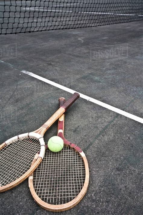 Tennis Rackets And Ball On Court Stock Photo Dissolve