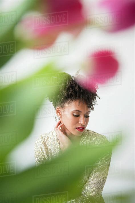 Pensive Glamorous Black Woman Behind Flowers Stock Photo Dissolve