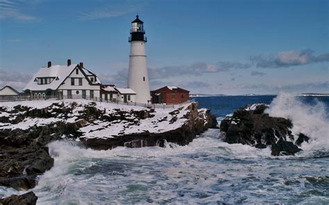 Lighthouse On A Rough Seashore In Winter Wide Desktop Background