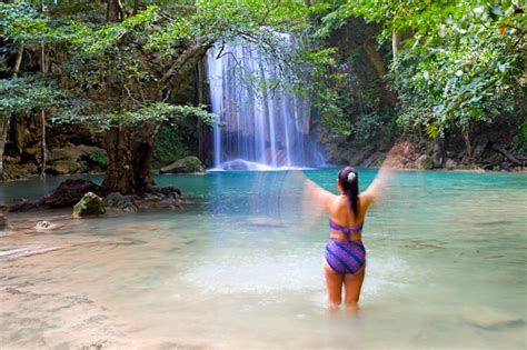 Woman With Swimsuit Enjoy In Water At Erawan Waterfall Stock Photo