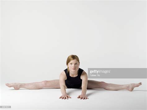 A Young Woman Practicing The Spread Leg Forward Fold Yoga Pose Photo
