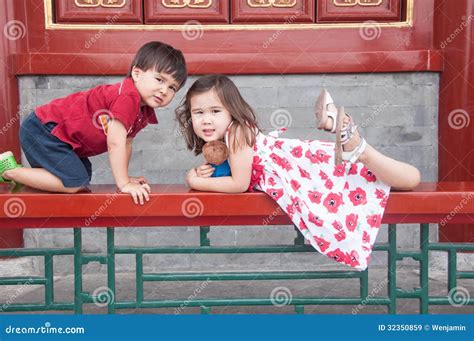 Mixed Race Siblings Playing At A Temple In Beijing China Stock Image