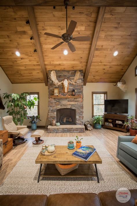 Rustic Living Room With Wood Vaulted Ceiling And Stone Fireplace