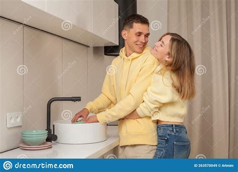 Lovely Happy Couple Laughing Hugging And Washing The Dishes Stock Image Image Of Interior