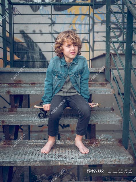 Barefoot Boy Sitting On Stairs With Skateboard — Curly Hair Skating