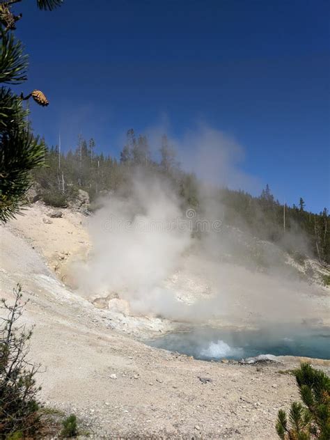 Steam Rising From Old Faithful Geyser At Yellowstone National Park
