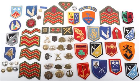 Selection Of Irish Army Insignia Including Cloth And Metal Cap Badges