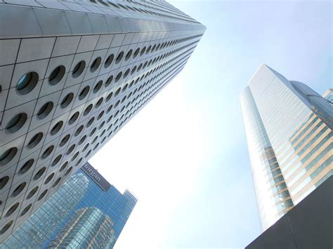 Exteriors Of Various Creative Skyscrapers Under Cloudless Blue Sky In