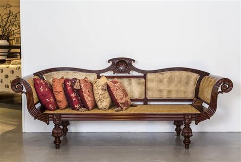 A British Colonial Sofa In Mahogany With An Arched Serpentine Crest
