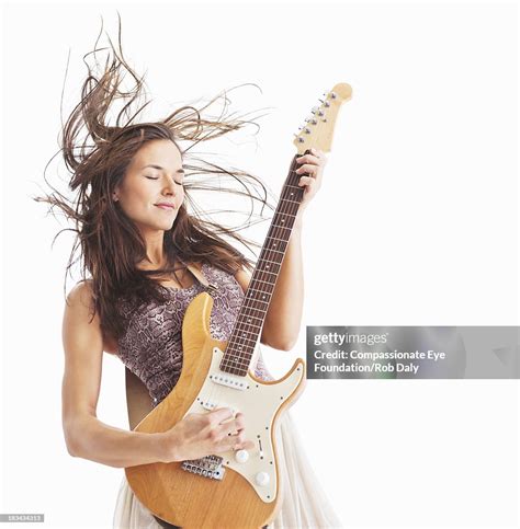 Woman Playing Electric Guitar With Hair Blowing High Res Stock Photo