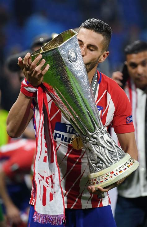 The trophy, a silver cup on a yellow marble plinth, was designed and crafted by the bertoni workshop in milan. Koke of Atletico Madrid kisses the trophy in victory ...