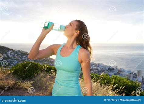 Active Woman Drinking From Water Bottle In Front Of The Sea Stock Photo Image Of Lady