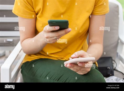 Female Hands With Two Mobile Phones Busy Concept Stock Photo Alamy