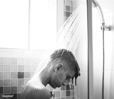 Download Premium Image Of Young Caucasian Man Showering In Bathroom