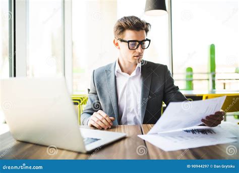 Businessman Working At Office With Laptop Tablet And Graph Data