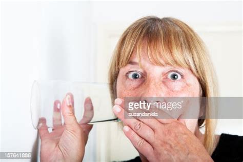 Nosey Woman Listens To Neighbours High Res Stock Photo Getty Images