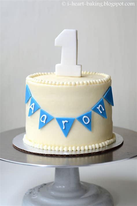 A bday cake with blue white and gray pastel color combination that fits to a baby 1st bday celebration with a decorative bunting. i heart baking!: baby first birthday carrot cake (with ...