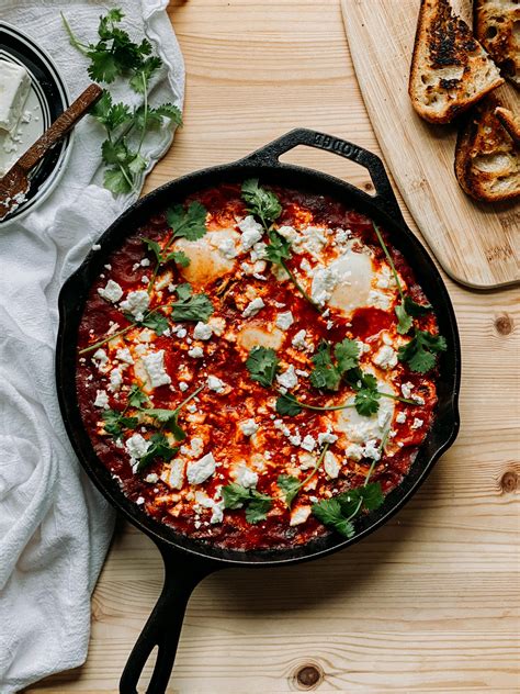 Shakshuka Eggs Poached In Tomato Sauce With Sausage Peppers And Feta