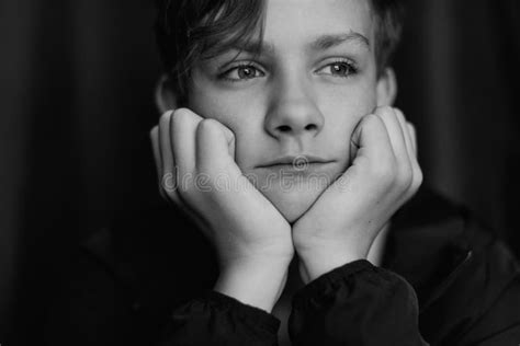 Black And White Portrait Of Teenage Boy On Dark Background Low Key
