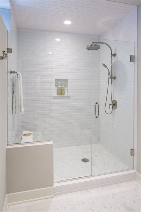 Gray and white marble tile with picket multicolored accent tiled shower. All white bathroom with subway tile even on the ceiling ...