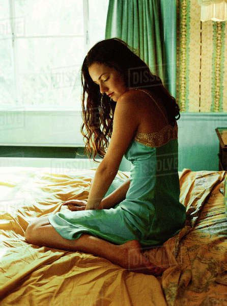 Caucasian Woman Sitting On Bed Stock Photo Dissolve