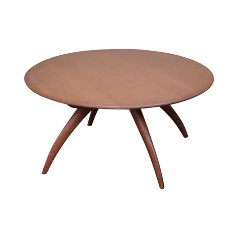 The walnut top rests on an ebonized wooden base with copper socks and a terrazzo stone circle in the centre. Heywood Wakefield Revolving Maple Coffee Table | Chairish