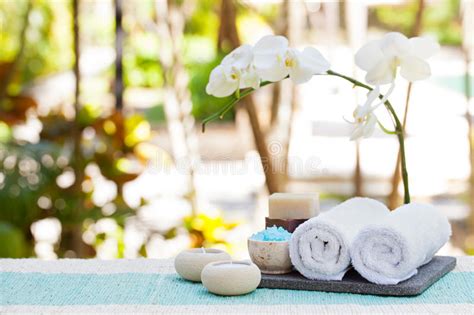 Spa And Wellness Massage Setting Still Life With Candle Towel And Stones Outdoor Summer