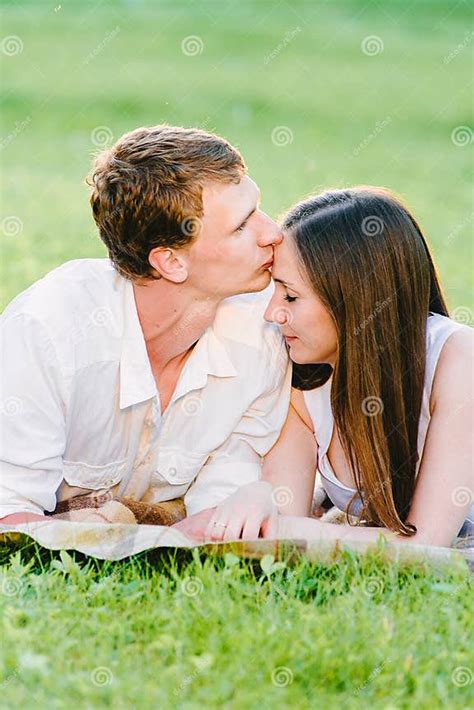 Portrait Picture Of A Man Kissing His Girl`s Forehead Stock Image