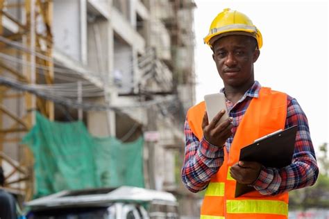Premium Photo Young Black African Man Construction Worker Holding
