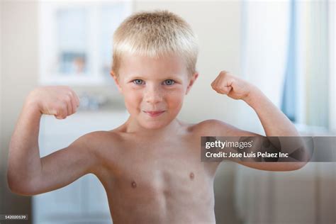Caucasian Boy Flexing His Muscles Foto De Stock Getty Images