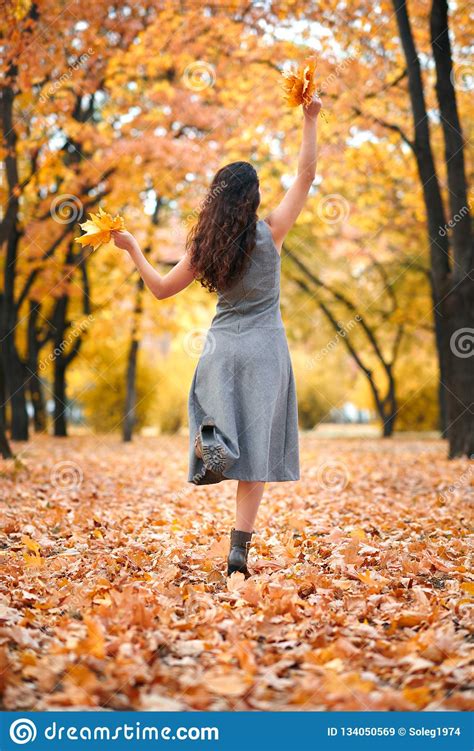 Pretty Woman Posing With Bunch Of Maple S Leaves In Autumn Park