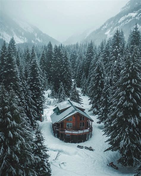 Mountain Cabin At A Snow Covered Coniferous Forest In The Pacific