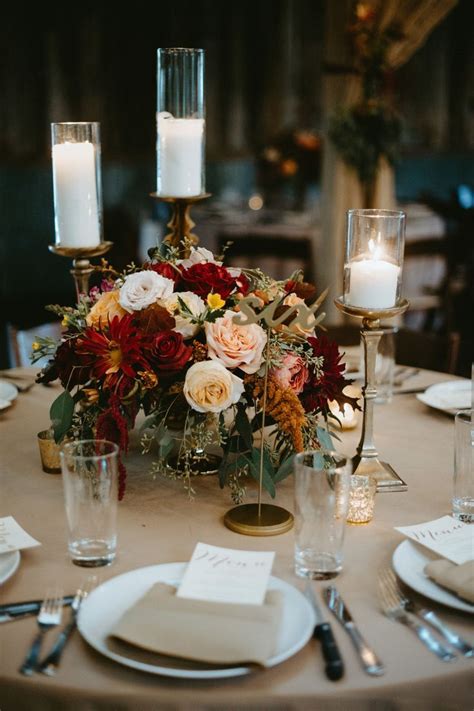 The Table Is Set With Candles Plates And Napkins For An Elegant Centerpiece