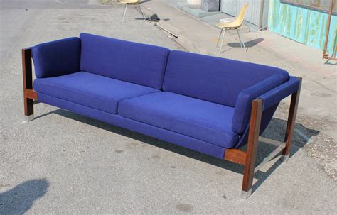 It was custom designed by the original. Milo Baughman Rosewood and Chrome Blue Sling Sofa at 1stdibs
