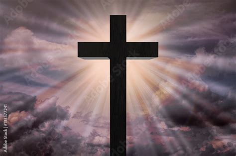 Jesus Christ Cross On A Sky With Dramatic Light Colorful Sunset Or