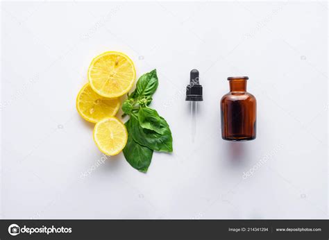 Top View Bottle Natural Herbal Essential Oil Dropper Lemon Pieces