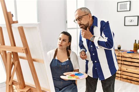 Senior Painting Teacher Man Teaching Art To Young Woman Painting On