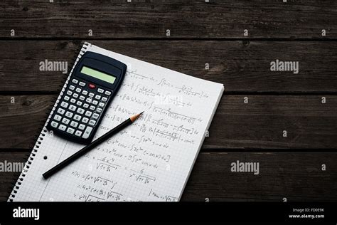 Maths Concept Handheld Calculator And Pencil Over A Sheet Of Paper