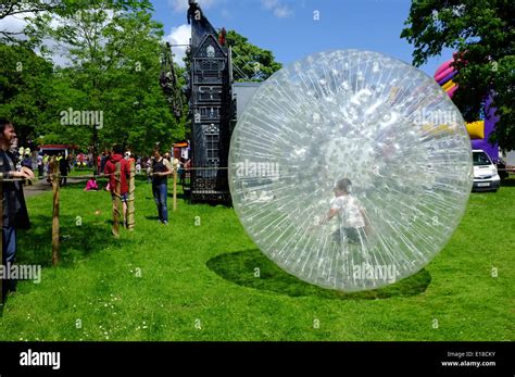 Child Playing Inside Inflatable Bubble In Wardown Park Luton Stock