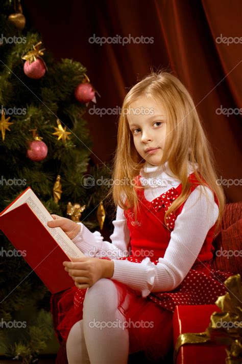Little Girl Reading Magic Book Near Christmas Tree — Stock Photo
