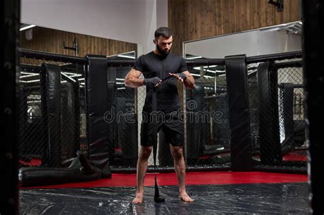 Man In Black Sportswear Preparing For Tough Fight Wrapping Fist In