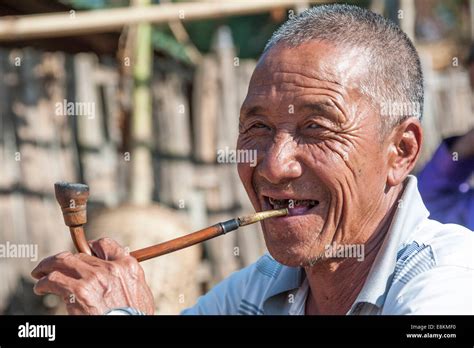 Elderly Man From The Akha People Hill Tribe Ethnic Minority Smoking A Pipe Portrait Chiang