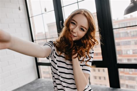 Free Photo Dreamy Caucasian Girl Making Selfie Elegant Ginger Woman Holding Smartphone And