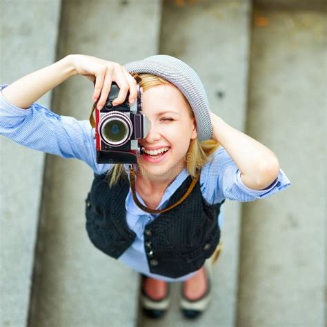 Hipster Girl Making Photo With Retro Camera On City Street Stock Image