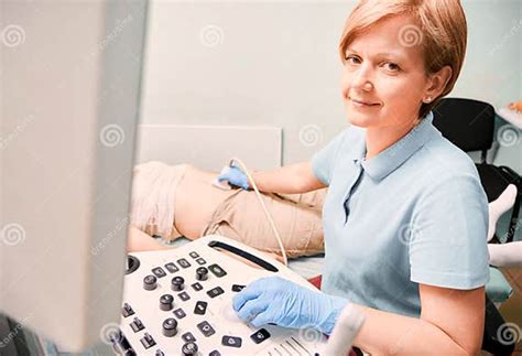 Female Doctor Doing Ultrasound Examination In Clinic Stock Image