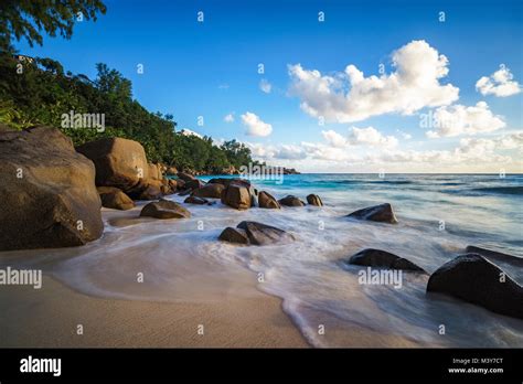 Beautiful Sunset At Paradise Tropical Beach With Granite Rocks And