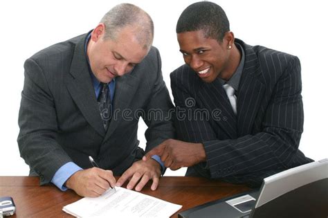 Businessmen Signing Contracts Two Men In Suits At Desk Signing Papers