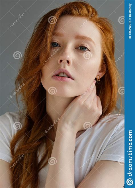Portrait Of A Beautiful Redhead Girl With Clean Skin Blue Eyes And